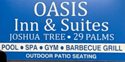 Signboard for Oasis Inn & Suites with amenities listed.