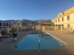 Hotel pool with mountain backdrop at sunrise