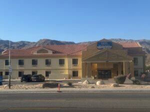 Oasis Inn and Suites with mountain backdrop