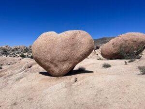Heart-shaped boulder under clear blue sky