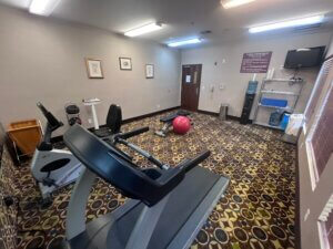 Small hotel fitness room with pink exercise ball