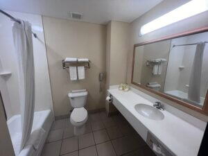 Small hotel bathroom with towels and mirror