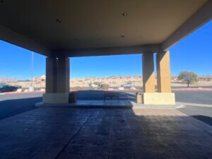 Shaded hotel entrance with desert hills