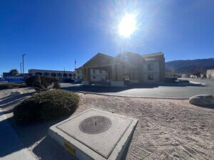 Sunlit motel entrance with desert mountains