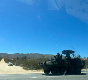 Armored vehicle with soldier under clear blue sky